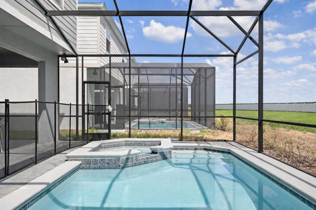 4428 Kaipo Road Davenport, FL 33897 - Photo 54 of 73 a view of swimming pool with a couches and table in the balcony