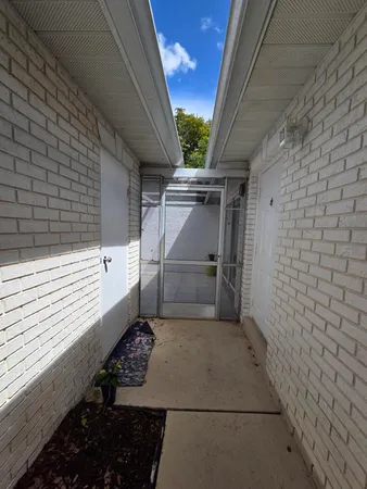 a view of a pathway of a house with an outdoor space