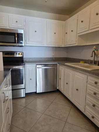 a kitchen with cabinets and appliances
