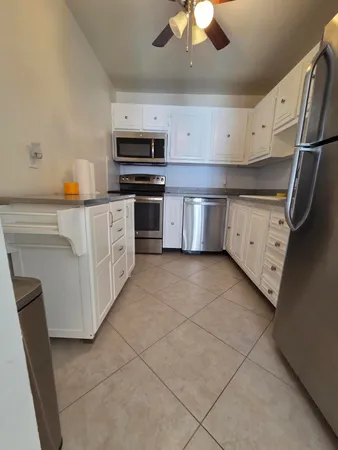 a living room with couches and a fireplace with wooden floor