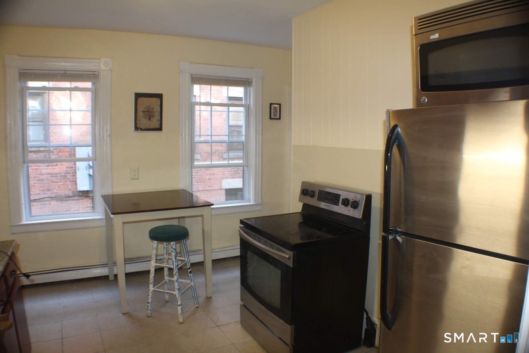150 Whitney Street Hartford, CT 06105 - Photo 24 of 39 a kitchen with stainless steel appliances granite countertop a refrigerator stove and microwave