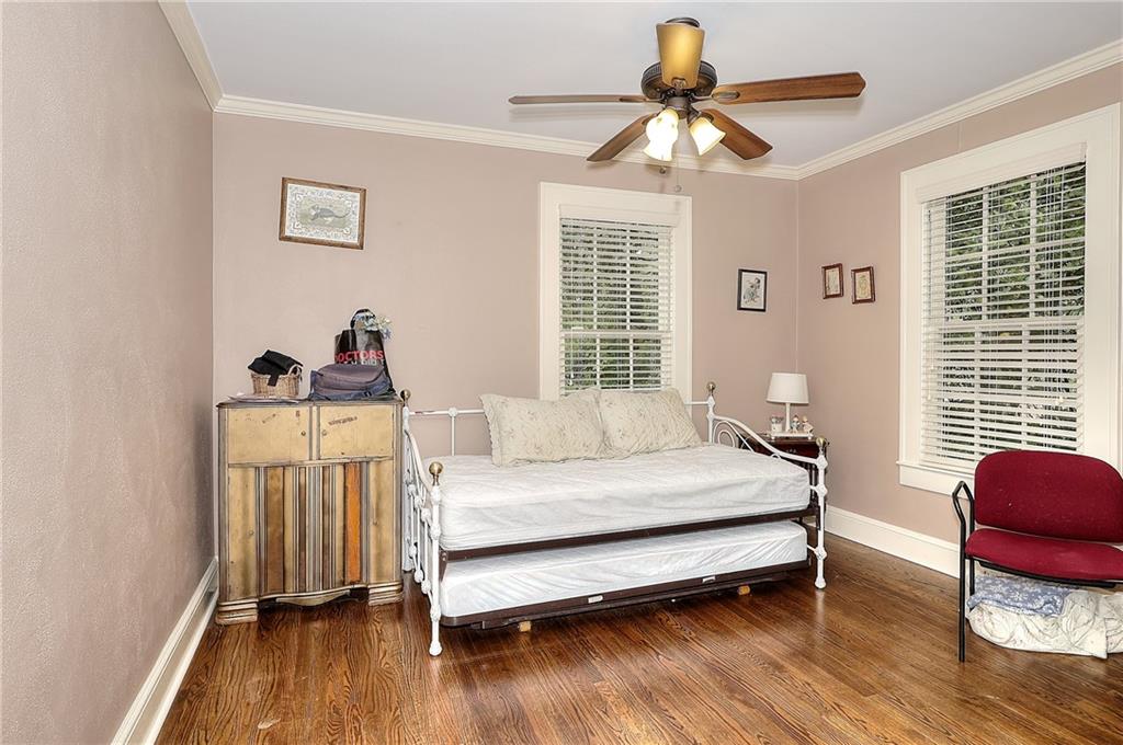 317 North Cherokee Road Social Circle, GA 30025 - Photo 24 of 32 a bedroom with a bed and a chandelier