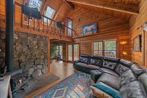 a living room with furniture a rug and a table