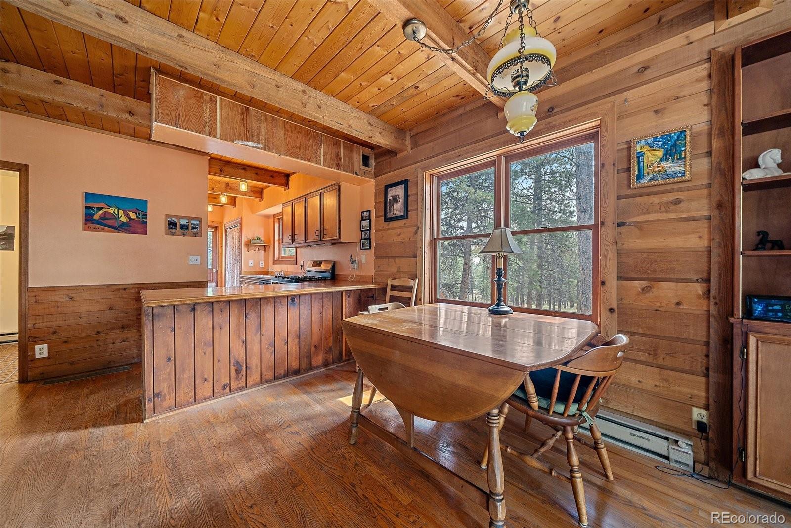 104 Six Bits Street Bailey, CO 80421 - Photo 12 of 46 a dining room with furniture window and wooden floor