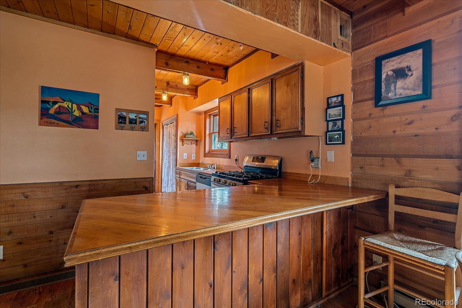 104 Six Bits Street Bailey, CO 80421 - Photo 13 of 46 a kitchen with a sink and cabinets