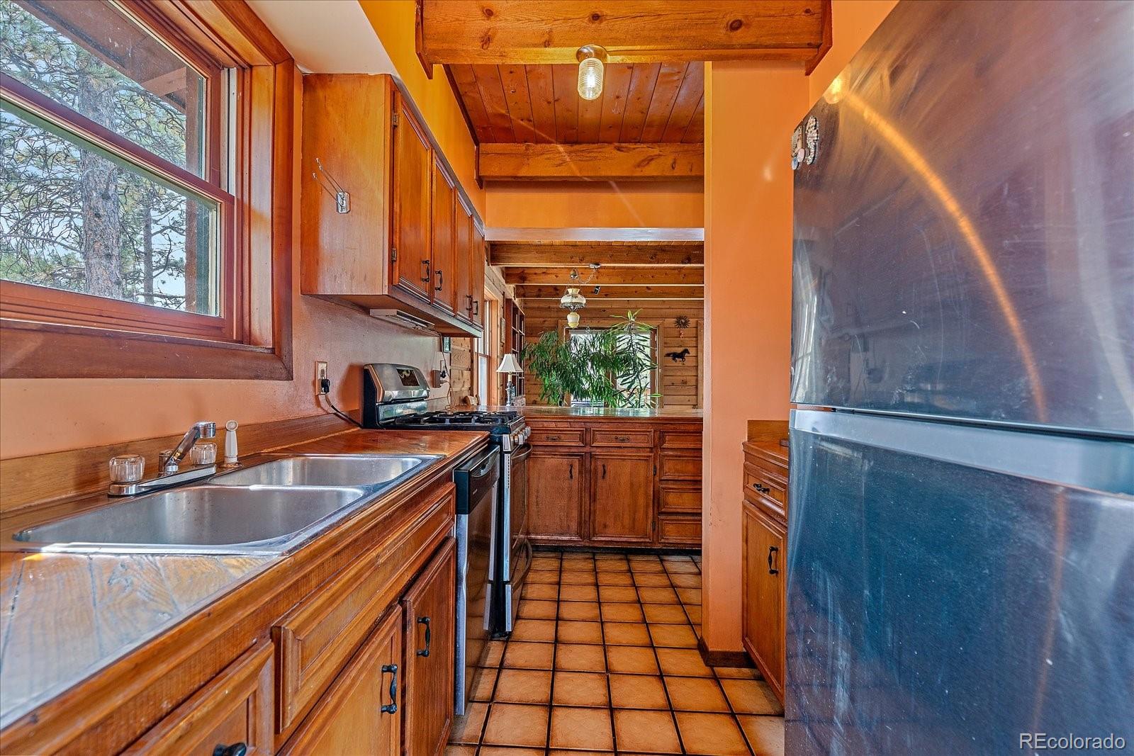 104 Six Bits Street Bailey, CO 80421 - Photo 15 of 46 a kitchen with a sink and a large window