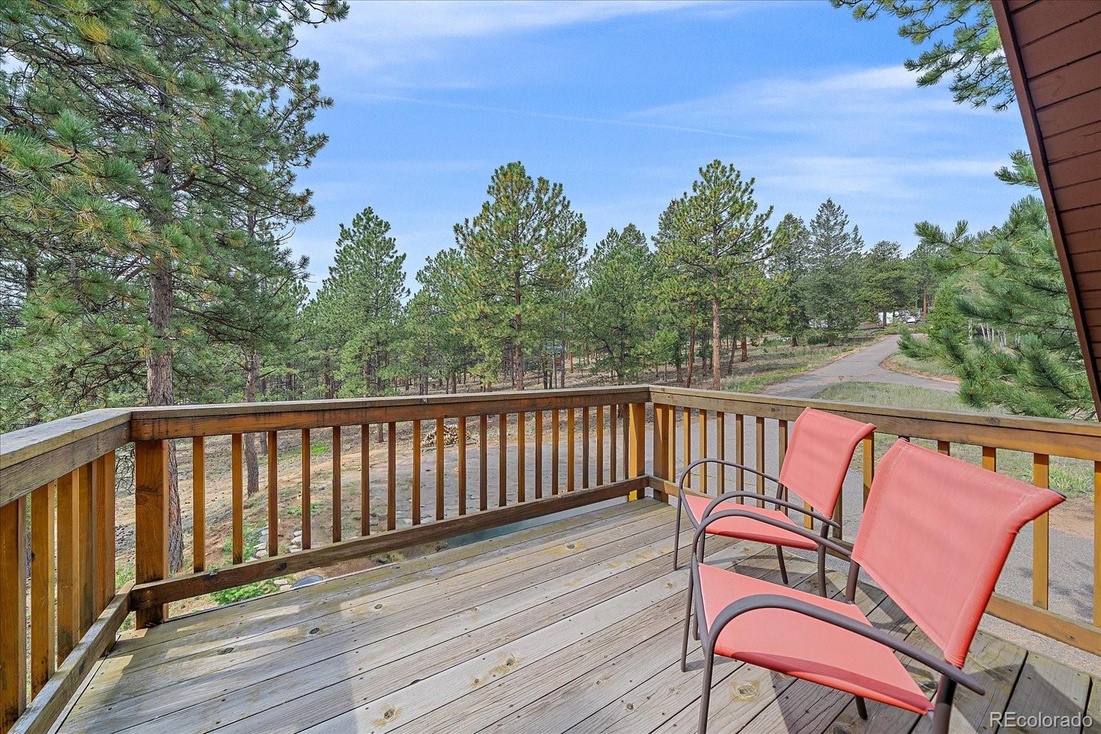 104 Six Bits Street Bailey, CO 80421 - Photo 20 of 46 a balcony with wooden floor and outdoor seating