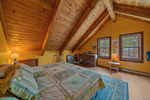 a bed sitting in a bedroom next to a window