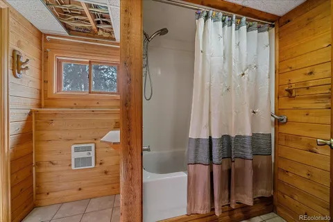 a bathroom with a shower and a sink