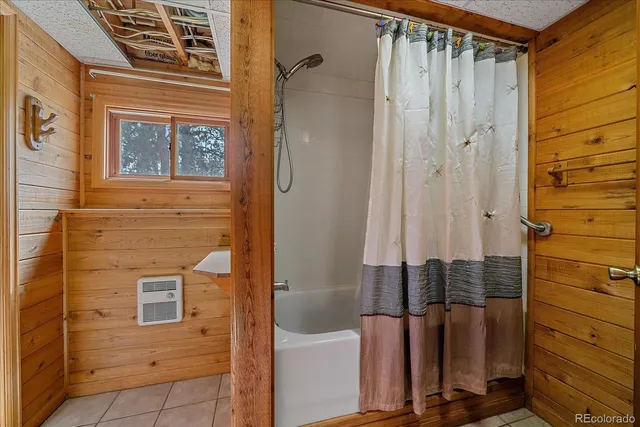 a bathroom with a shower and a sink