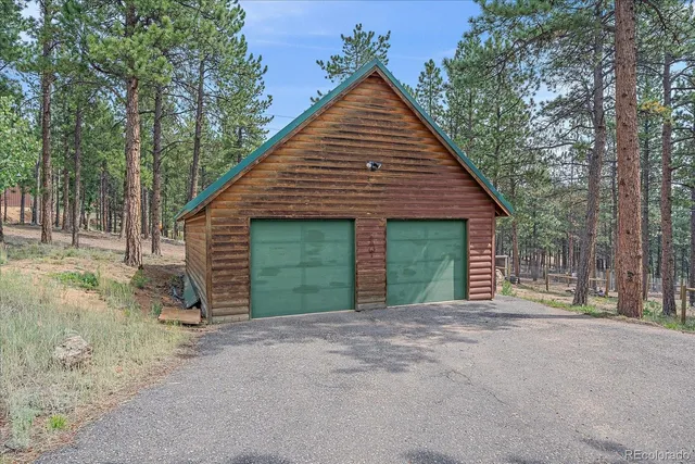 front view of a house with a yard and garage