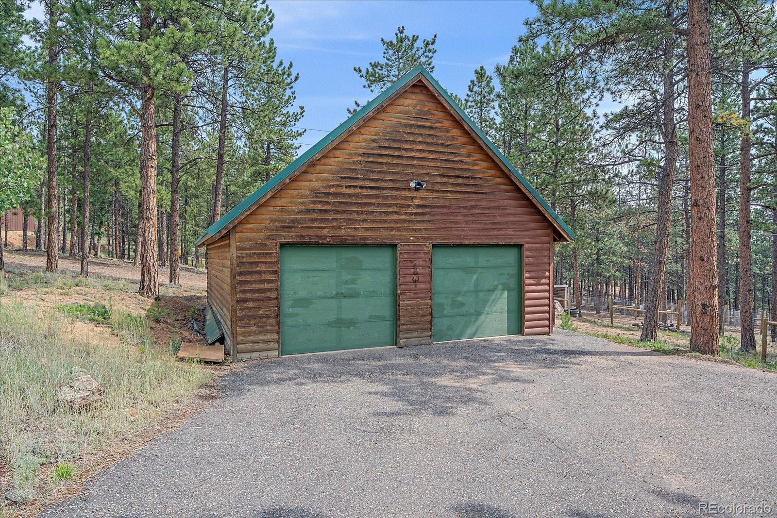 104 Six Bits Street Bailey, CO 80421 - Photo 44 of 46 front view of a house with a yard and garage