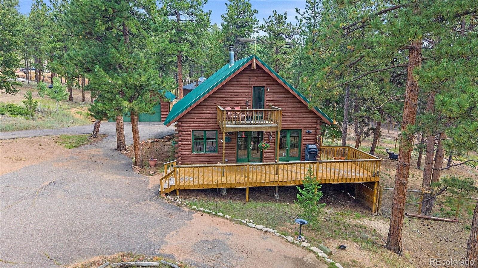 104 Six Bits Street Bailey, CO 80421 - Photo 6 of 46 a view of backyard with deck and trees