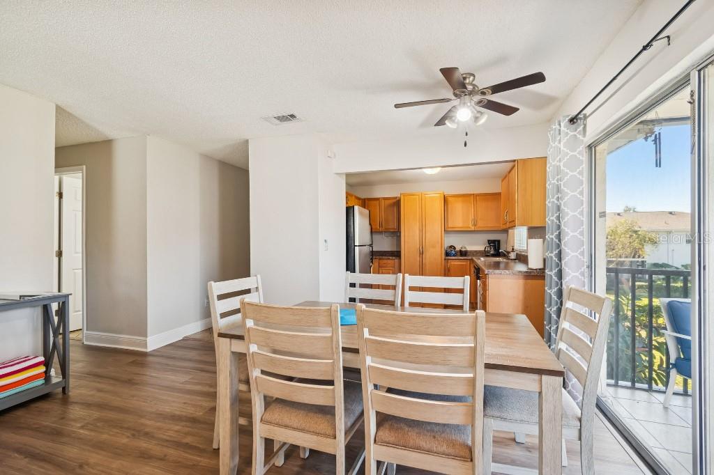 13125 Wilcox Road, Unit 6205 Largo, FL 33774 - Photo 8 of 48 a living room with furniture a wooden floor and a large window