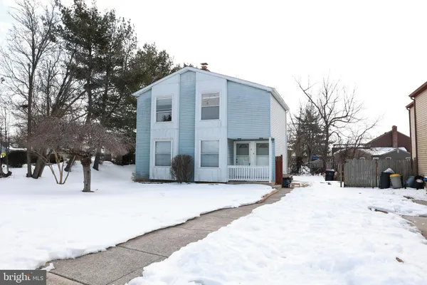 a view of a house with snow on the road