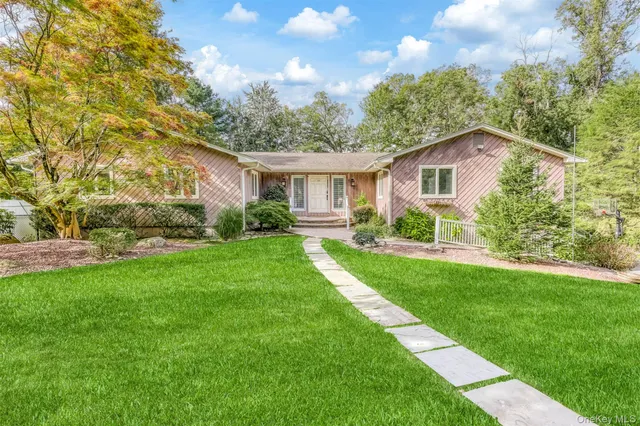 a front view of house with yard and green space
