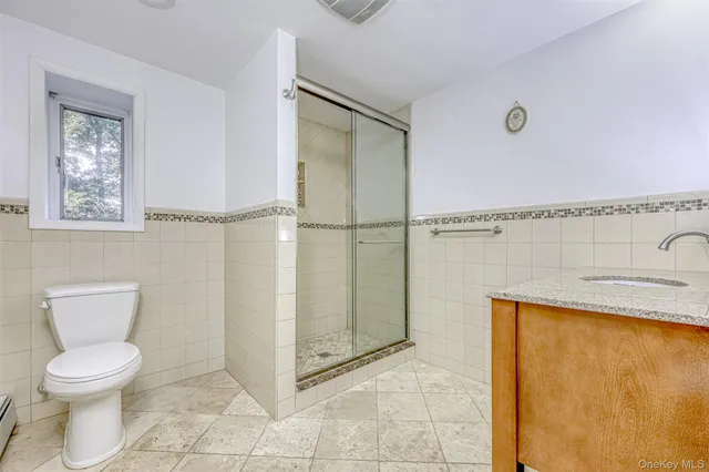 a bathroom with a toilet a sink and a shower