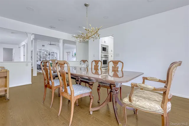 a view of a dining room with furniture and a chandelier
