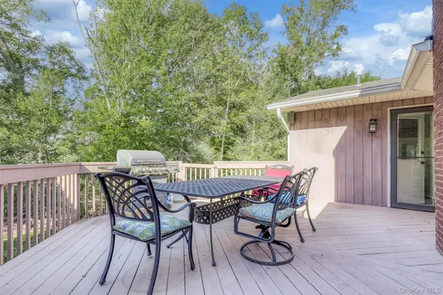 a patio of a house with table and chairs
