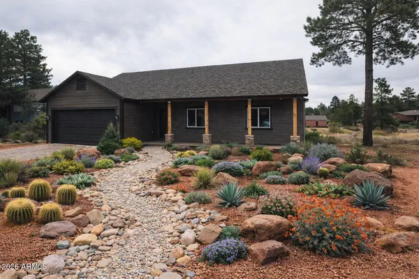a front view of house with a garden