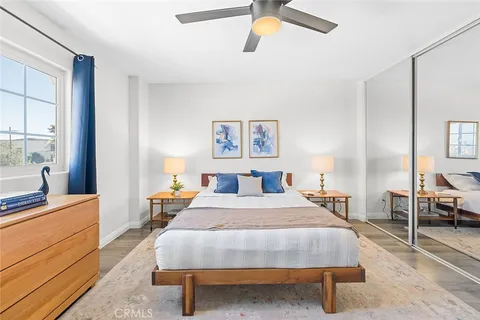 a bedroom with a bed a table and chair