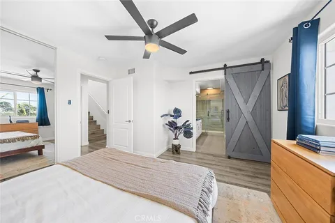 a bedroom with a large bed and a chandelier