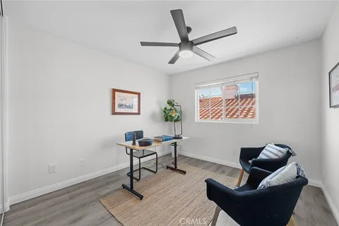 a living room with couches a coffee table and a window with wooden floor