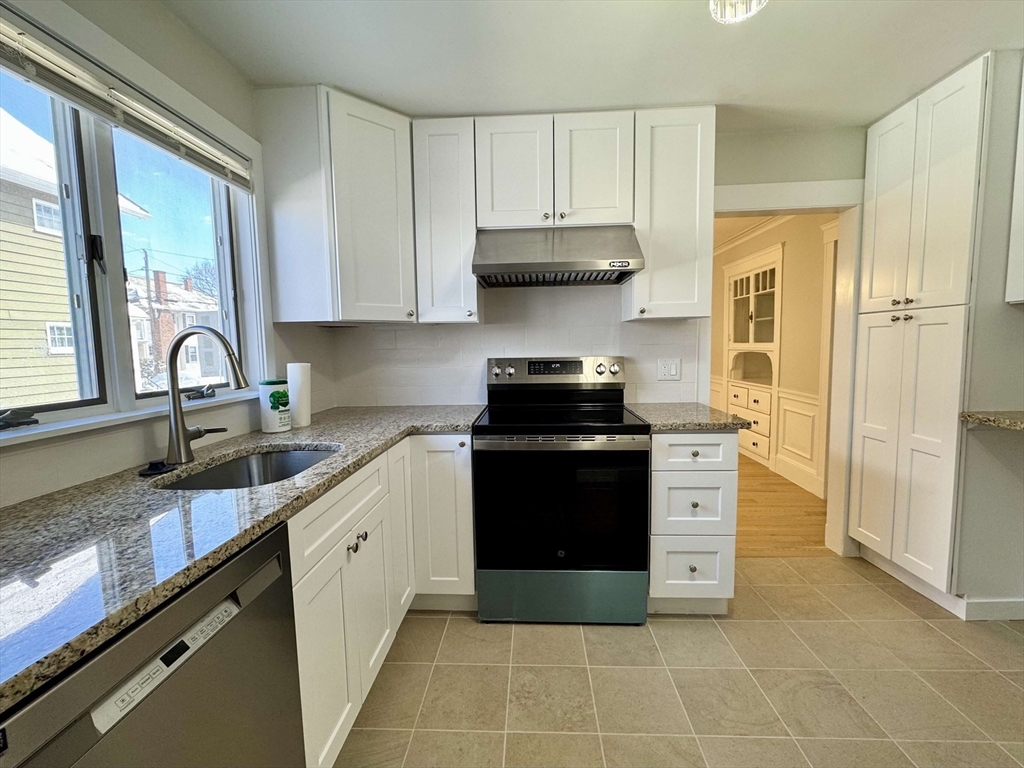 42 Chester Road, Unit 1 Belmont, MA 02478 - Photo 1 of 22 a kitchen with a sink stove and refrigerator