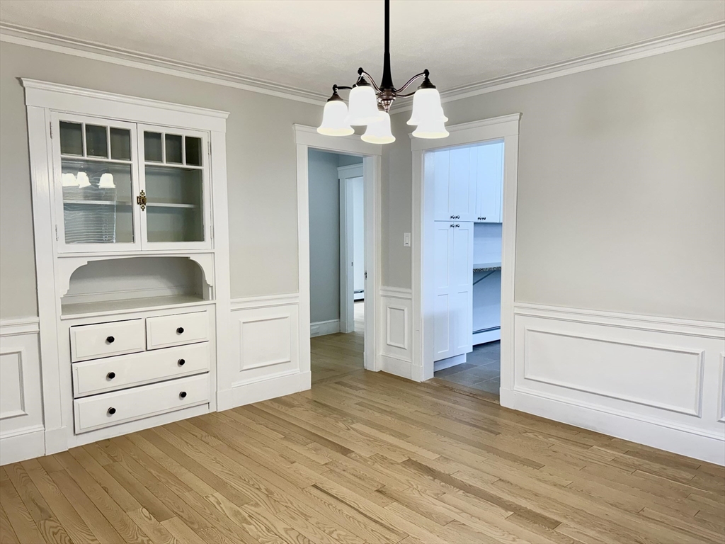 42 Chester Road, Unit 1 Belmont, MA 02478 - Photo 11 of 22 a view of an empty room with wooden floor and cabinet