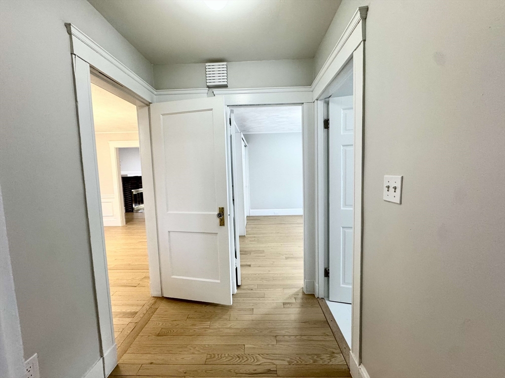 42 Chester Road, Unit 1 Belmont, MA 02478 - Photo 21 of 22 a view of a hallway with wooden floor and a bathroom