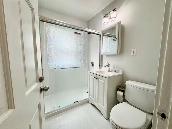 a white toilet sitting next to a bathroom sink