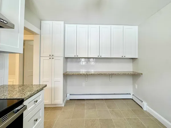 a kitchen with granite countertop a sink and a stove