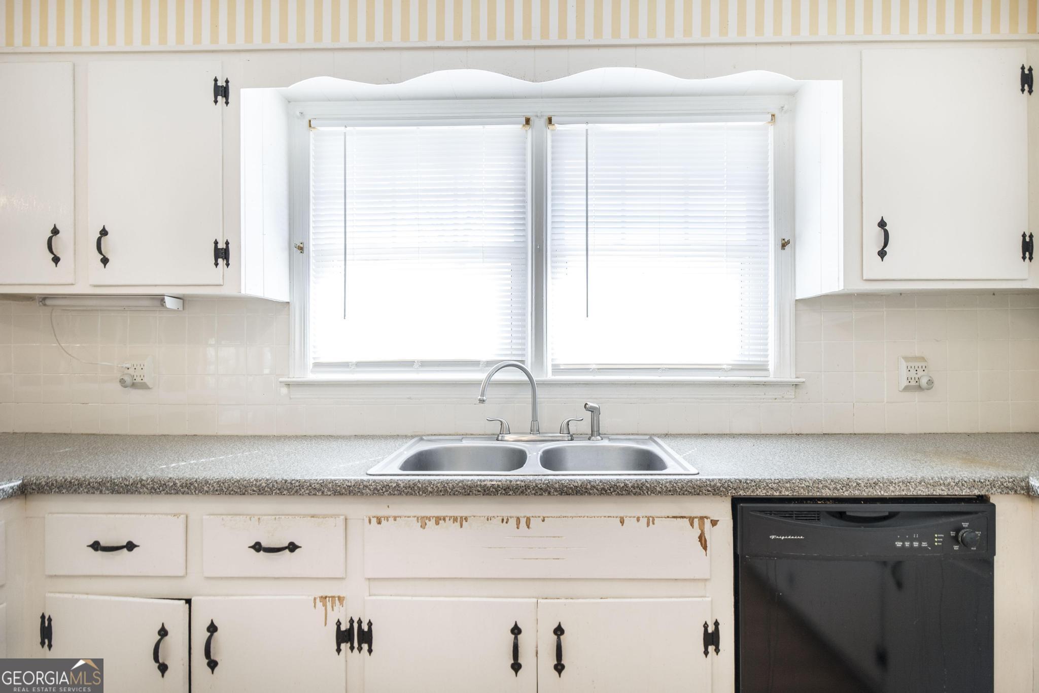 1739 Houston Lake Road Perry, GA 31069 - Photo 12 of 34 a kitchen with granite countertop white cabinets and a sink