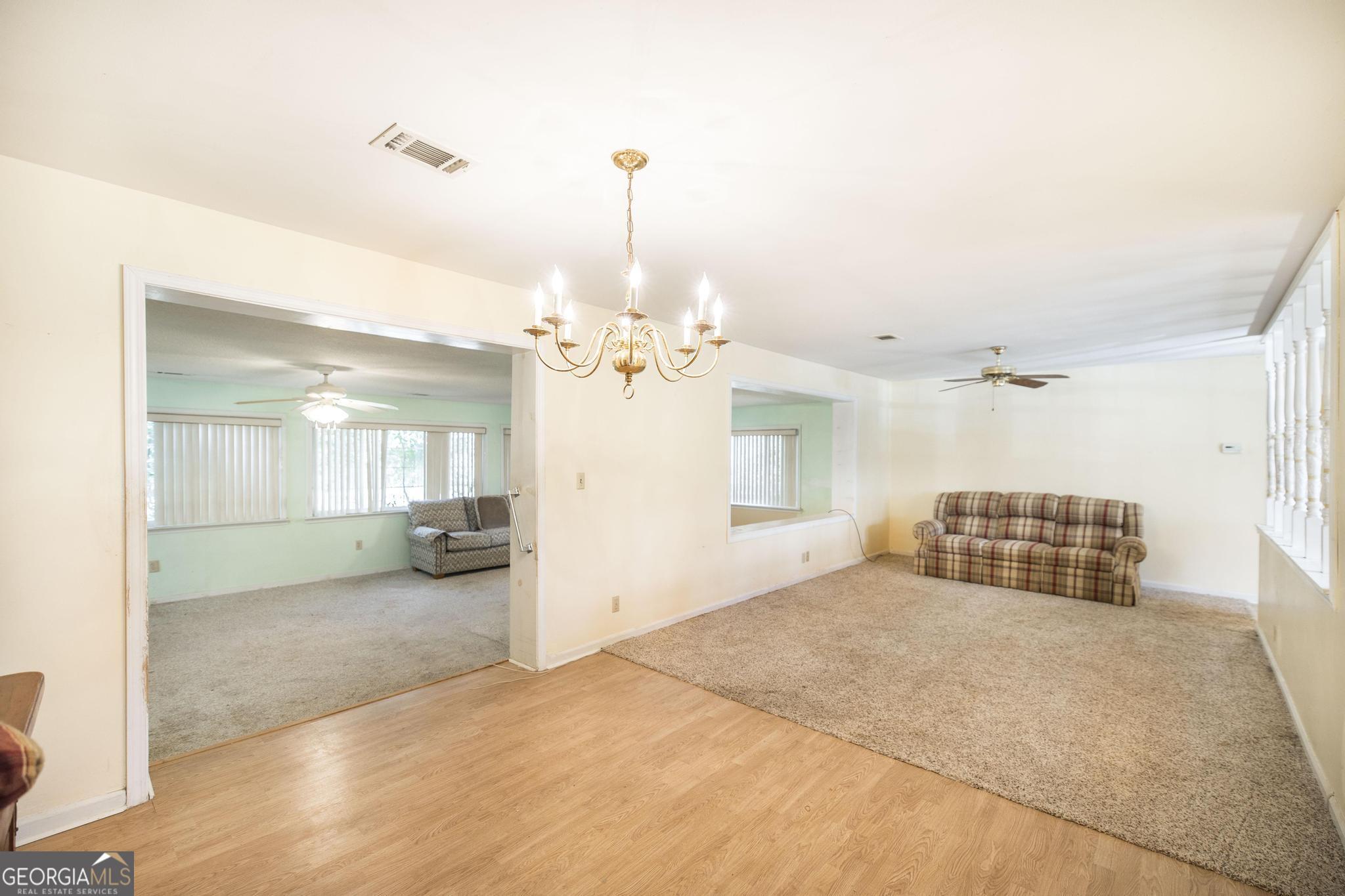 1739 Houston Lake Road Perry, GA 31069 - Photo 14 of 34 a spacious bedroom with a bed and ceiling fan