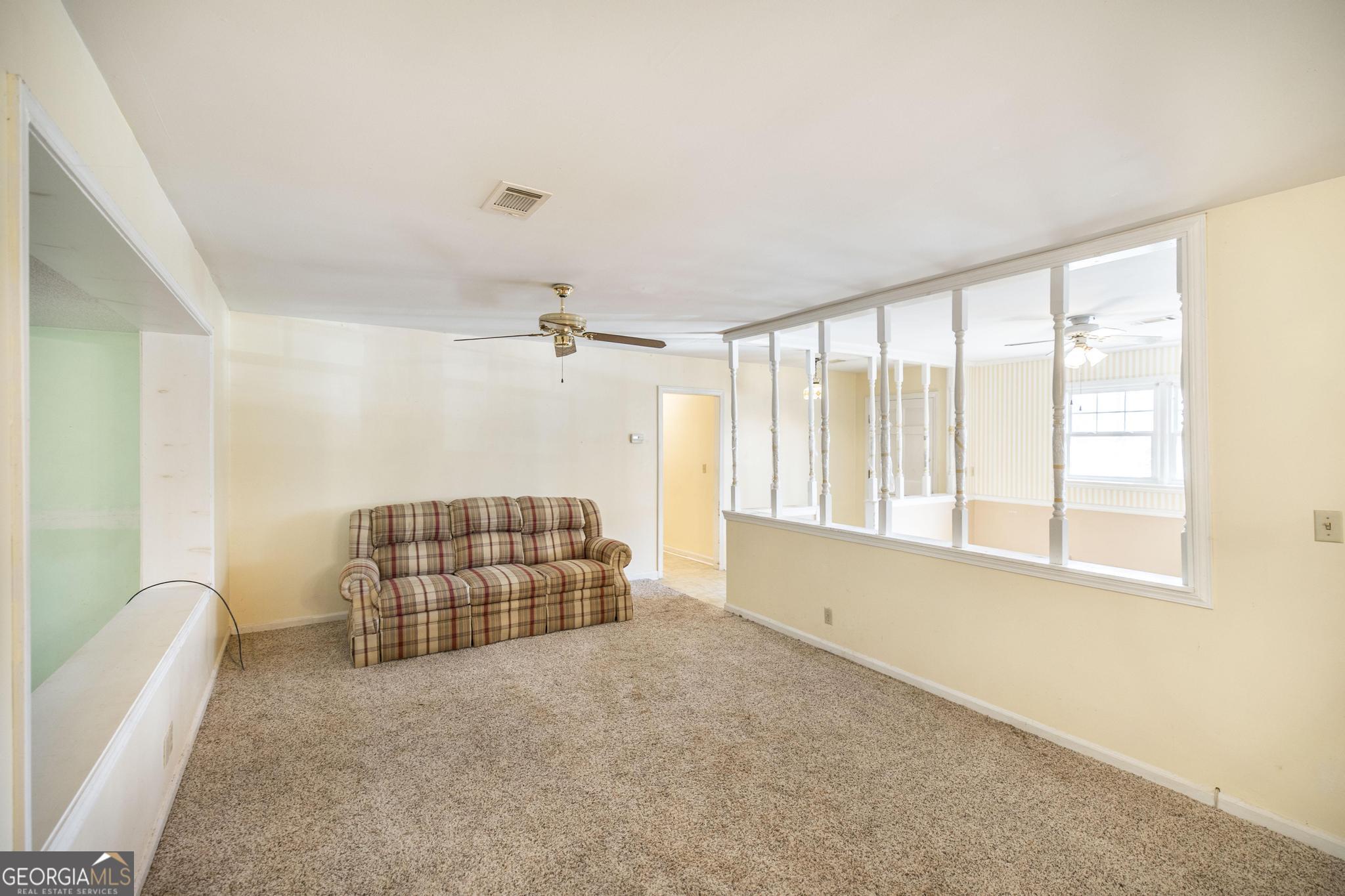 1739 Houston Lake Road Perry, GA 31069 - Photo 15 of 34 a living room with furniture and a window