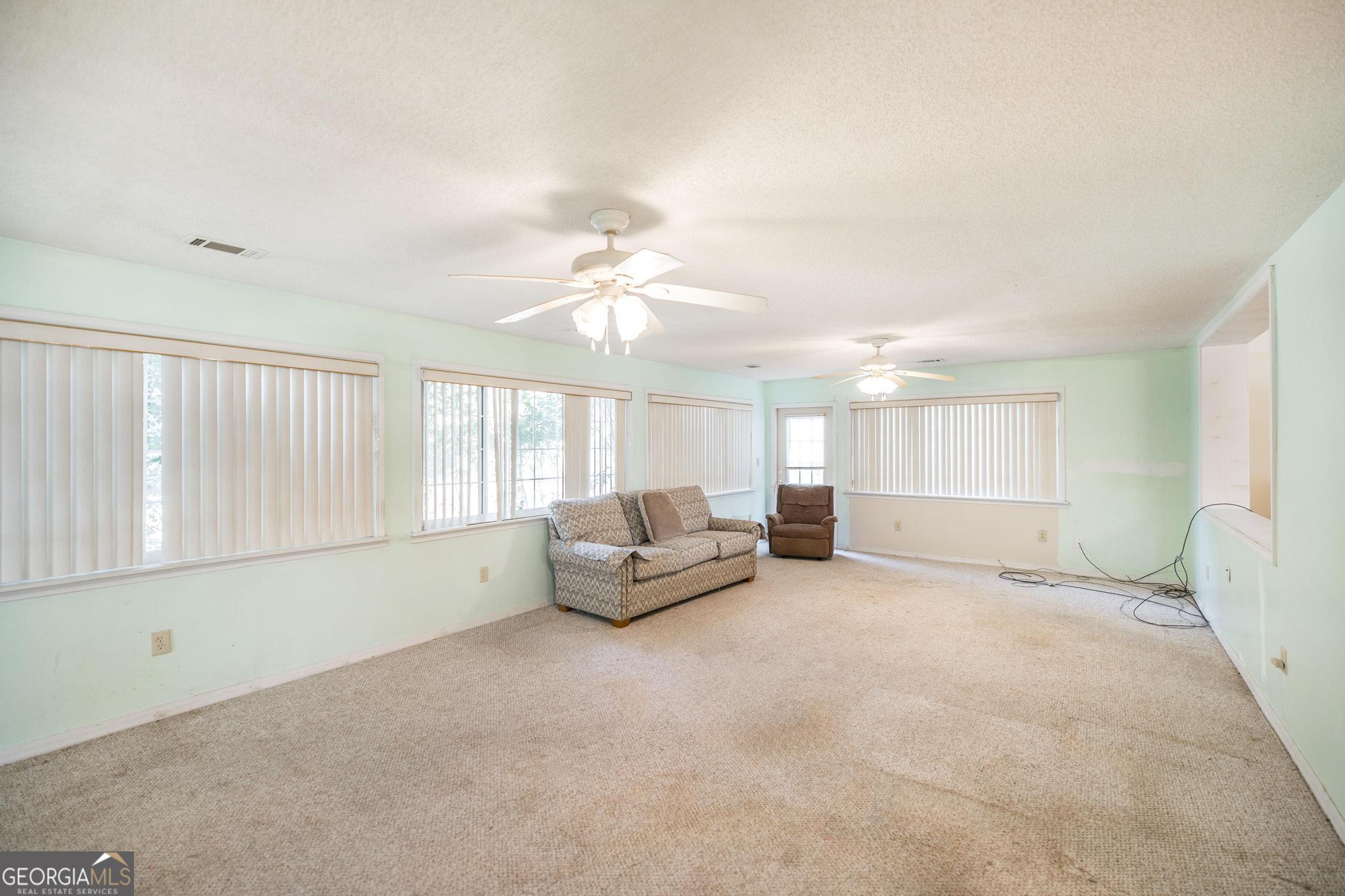 1739 Houston Lake Road Perry, GA 31069 - Photo 17 of 34 a living room with furniture and a large window