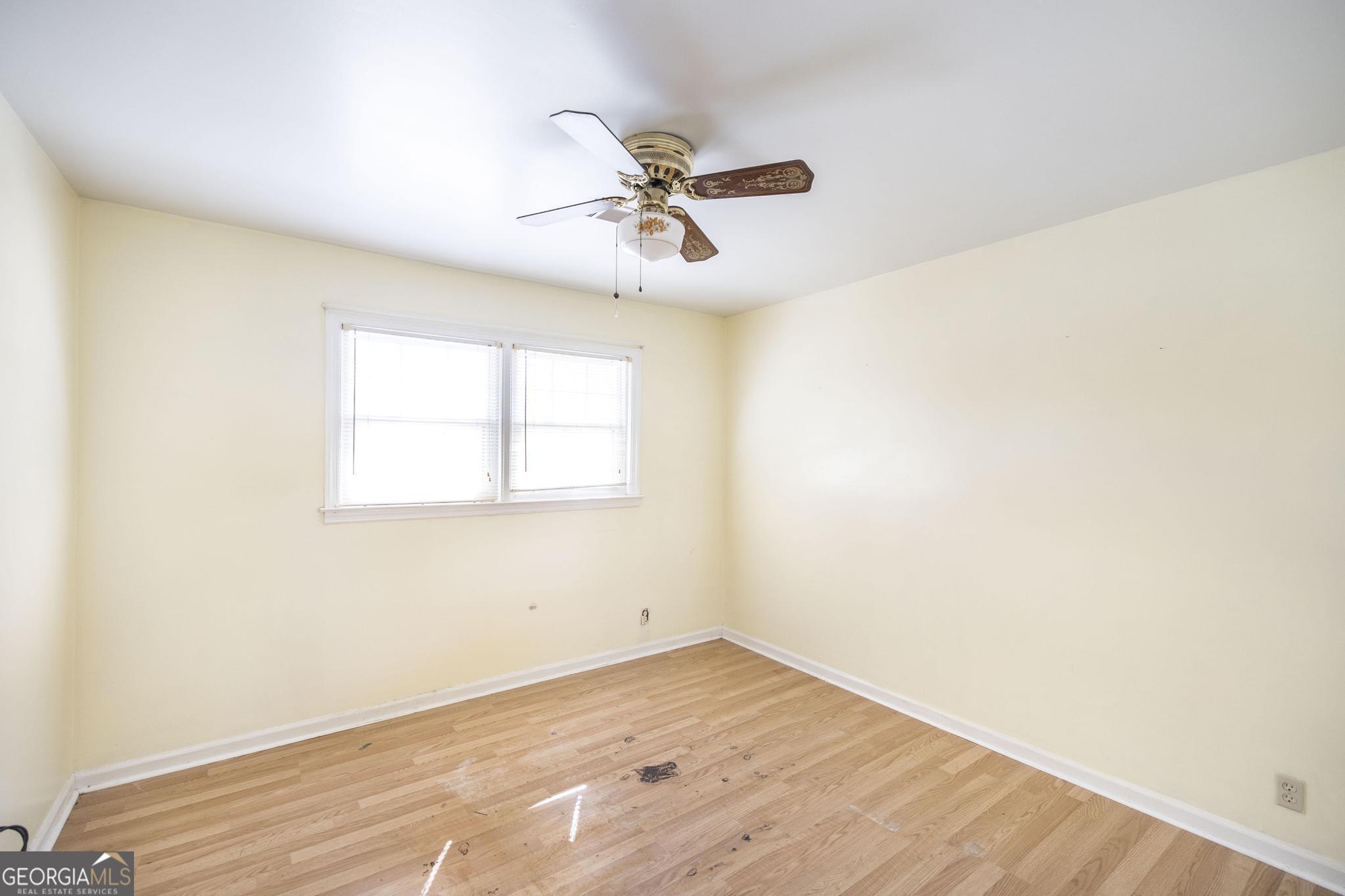 1739 Houston Lake Road Perry, GA 31069 - Photo 21 of 34 a view of empty room with wooden floor and fan