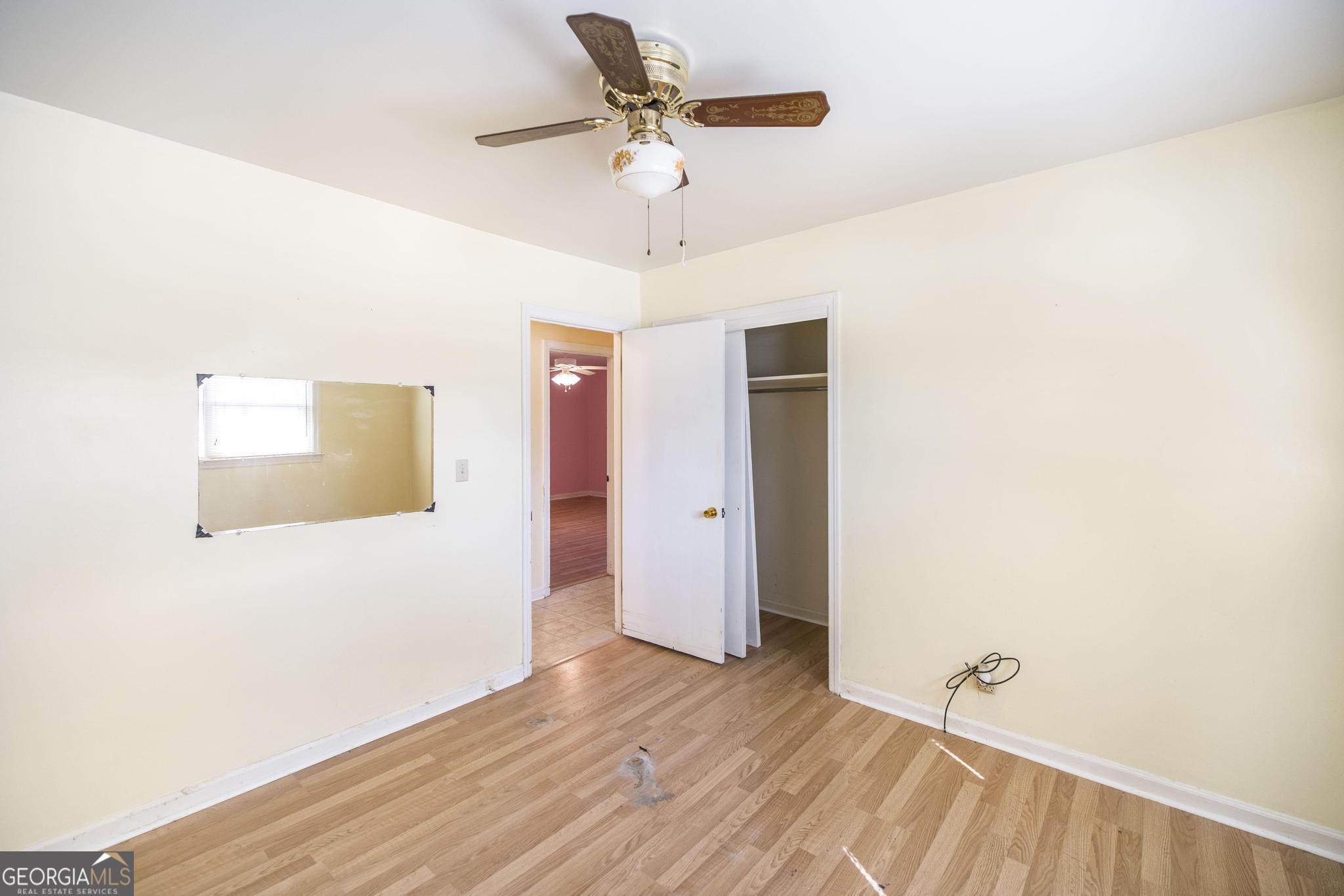 1739 Houston Lake Road Perry, GA 31069 - Photo 22 of 34 a view of an empty room with window and wooden floor