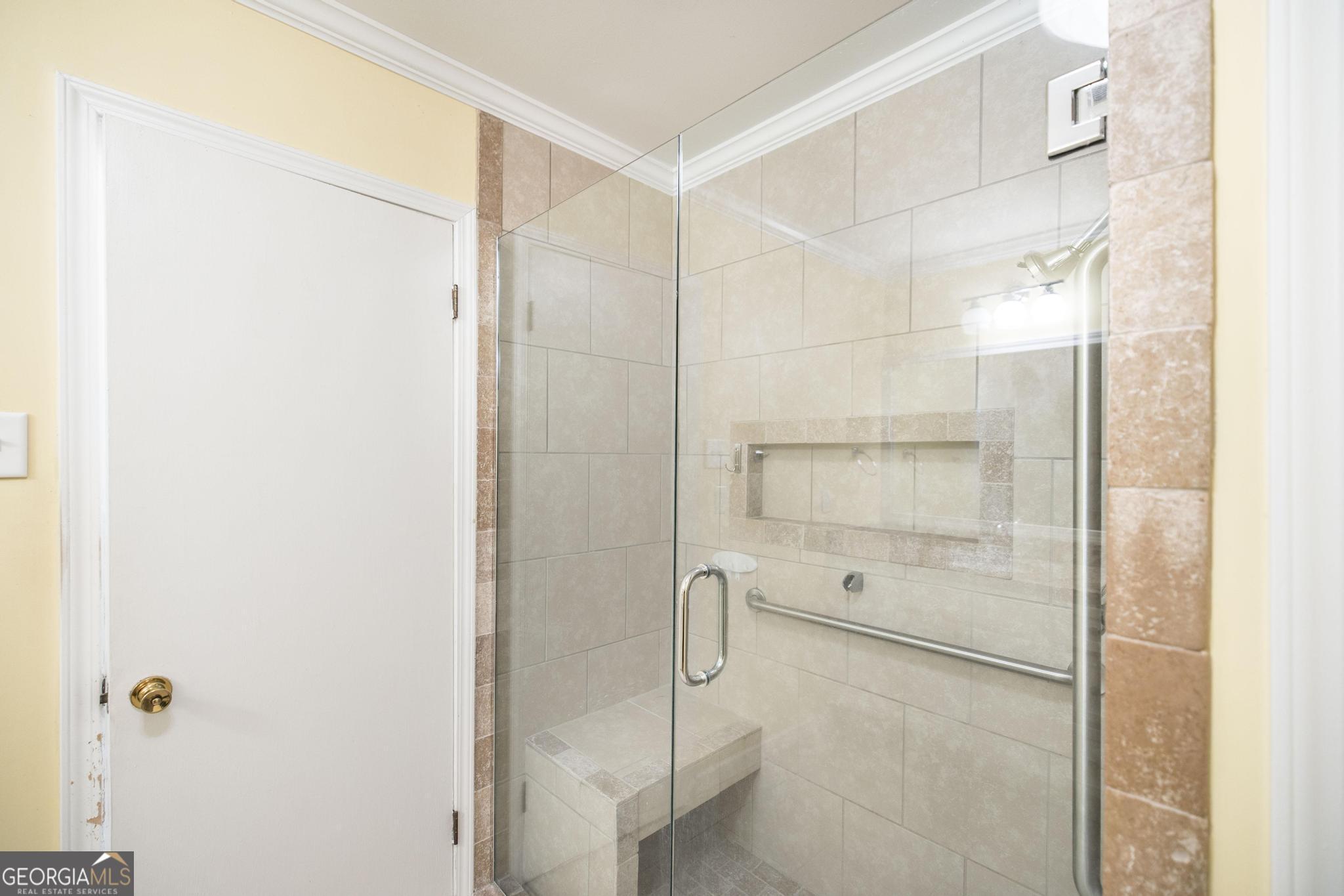 1739 Houston Lake Road Perry, GA 31069 - Photo 24 of 34 a bathroom with a glass shower door