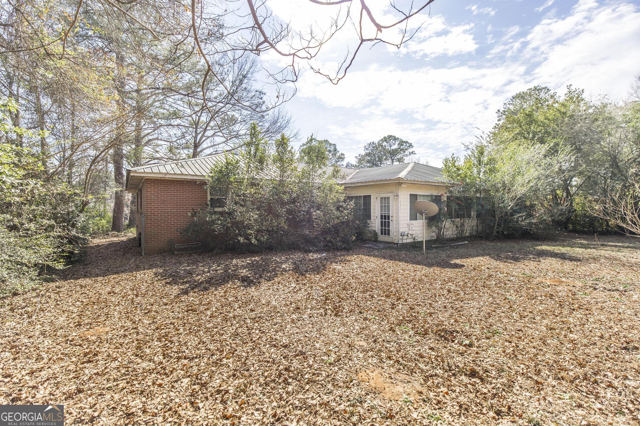 1739 Houston Lake Road Perry, GA 31069 - Photo 32 of 34 a front view of a house with a yard and a garage