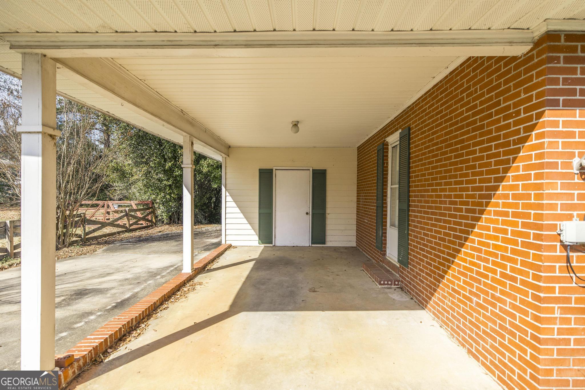 1739 Houston Lake Road Perry, GA 31069 - Photo 4 of 34 a view of a balcony and floor to ceiling windows with wooden floor