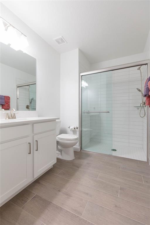 10806 Gable Dig Loop San Antonio, FL 33576 - Photo 32 of 73 a bathroom with a double vanity sink toilet and shower