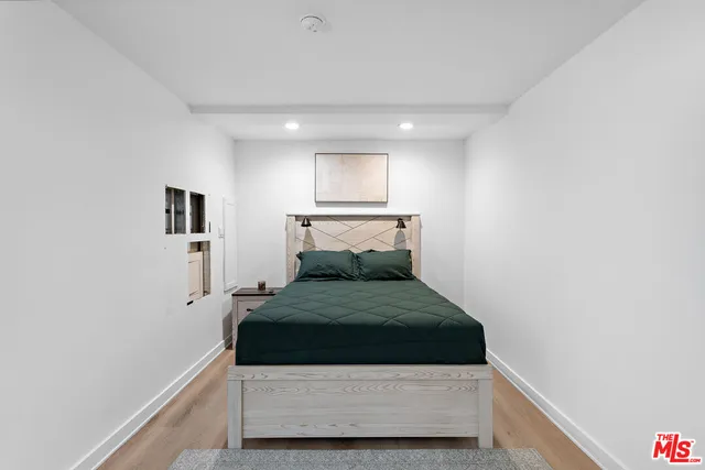 a room with a bed and dresser