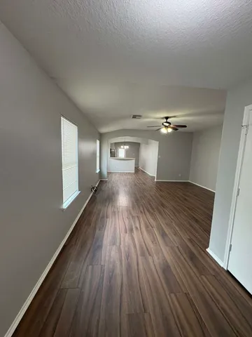 wooden floor in an empty room with a window