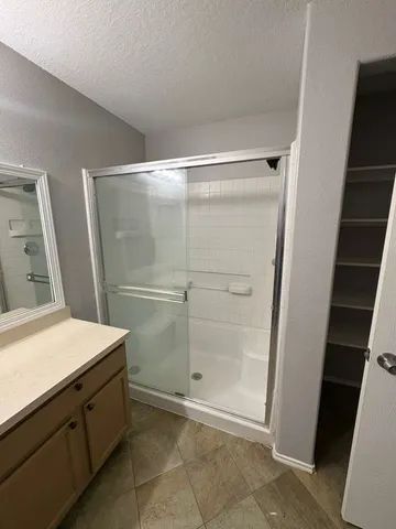 a bathroom with a shower and a sink