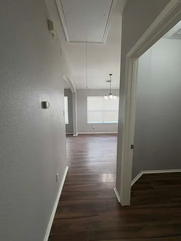 a view of a hallway with wooden floor