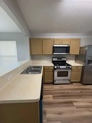 a kitchen with a stove and a microwave