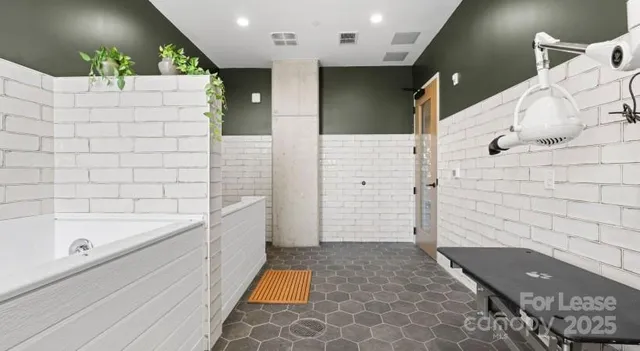 a bathroom with a bathtub and shower
