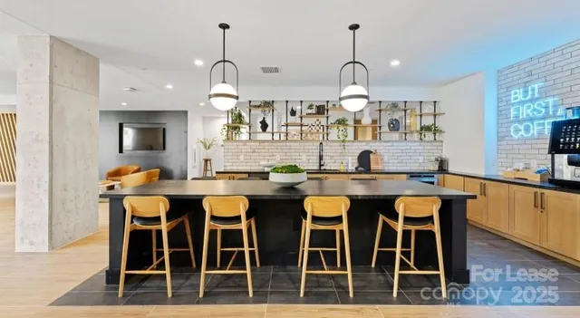 a dining room with wooden floor a chandelier a wooden table and chairs