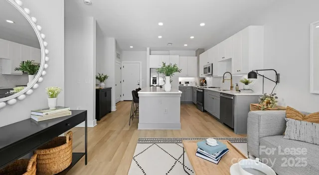 a large kitchen with stainless steel appliances kitchen island granite countertop a sink and cabinets